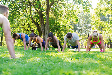 Image showing group of friends or sportsmen exercising outdoors