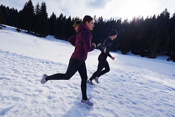 Image showing couple jogging outside on snow