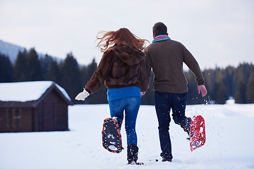 Image showing couple having fun and walking in snow shoes