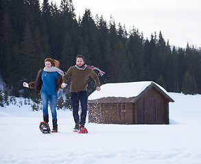 Image showing couple having fun and walking in snow shoes