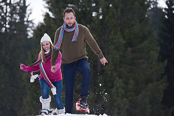 Image showing couple having fun and walking in snow shoes