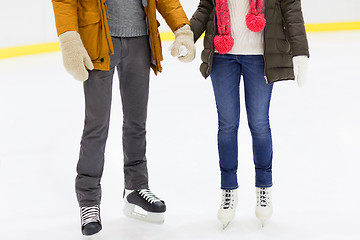 Image showing close up of happy couple skating on ice rink