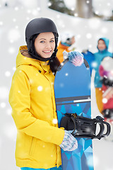 Image showing happy friends in helmets with snowboards