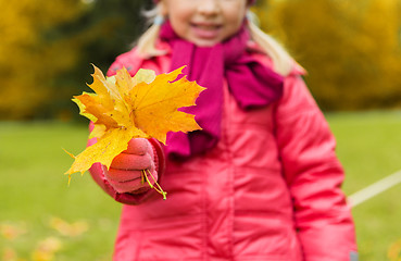 Image showing close up of happy girl with autumnn maple leaves