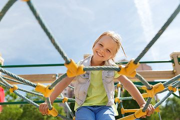 Image showing happy little girl climbing on children playground