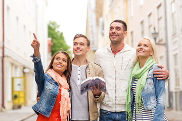 Image showing group of friends with city guide exploring town