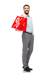 Image showing smiling man with red shopping bag