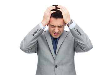 Image showing businessman in suit having head ache