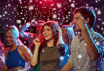 Image showing group of happy friends dancing in night club