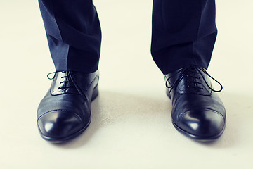 Image showing close up of man legs in elegant shoes with laces