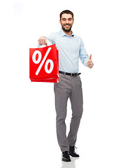 Image showing smiling man with red shopping bag