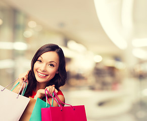 Image showing smiling young woman with shopping bags