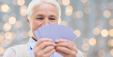 Image showing close up of happy senior woman playing cards