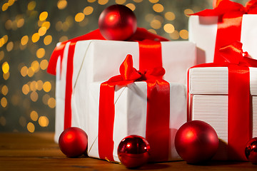 Image showing gift boxes and red balls on wooden floor