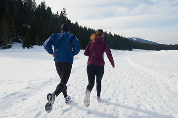 Image showing couple jogging outside on snow