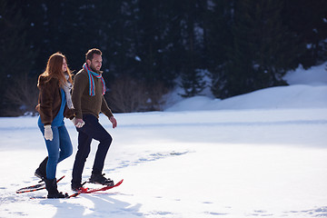 Image showing couple having fun and walking in snow shoes