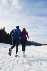 Image showing couple jogging outside on snow