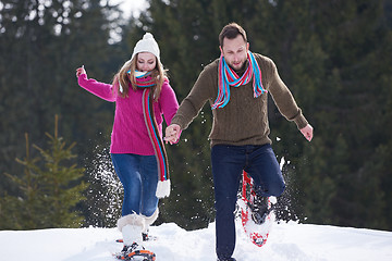 Image showing couple having fun and walking in snow shoes