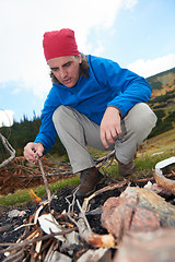 Image showing hiking man try to light fire