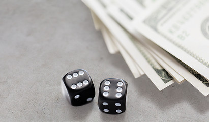 Image showing close up of black dice and dollar cash money