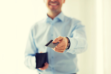 Image showing close up of man holding wallet and credit card