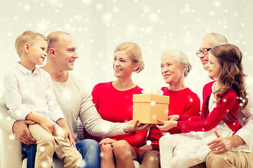 Image showing smiling family with gift at home