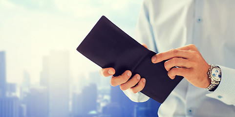 Image showing close up of businessman hands holding open wallet