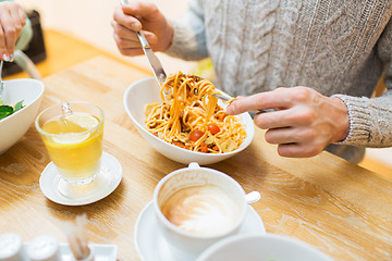 Image showing close up man eating pasta for dinner at restaurant