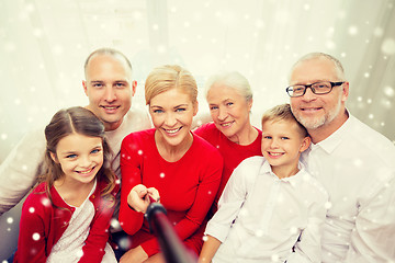 Image showing smiling family with selfie stick photographing