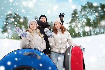 Image showing group of smiling friends with snow tubes