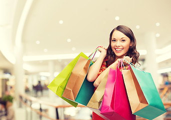 Image showing smiling young woman with shopping bags