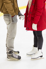 Image showing close up of happy couple skating on ice rink