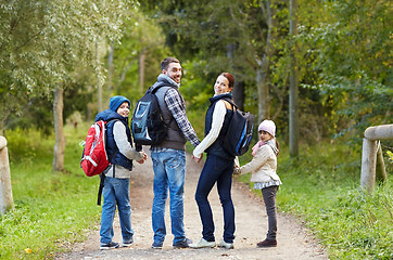 Image showing happy family with backpacks hiking walking