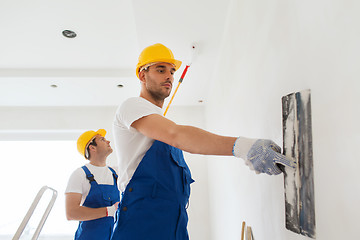 Image showing group of builders with tools indoors