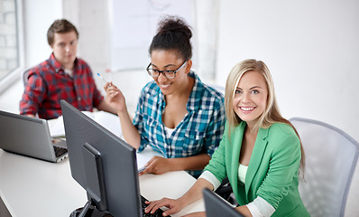 Image showing happy high school students in computer class