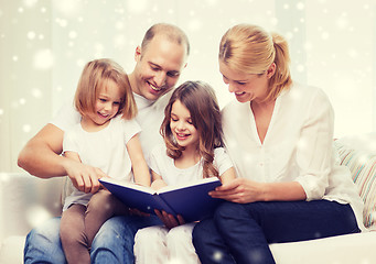 Image showing happy family with book at home