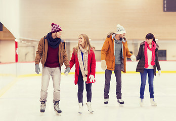 Image showing happy friends on skating rink