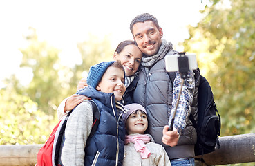 Image showing happy family with smartphone selfie stick in woods