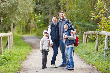 Image showing happy family with backpacks hiking