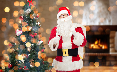 Image showing santa claus with bag showing thumbs up at home