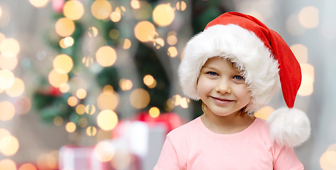 Image showing smiling little girl in santa hat at home