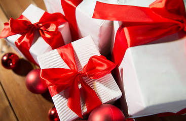 Image showing close up of gift boxes and red christmas balls