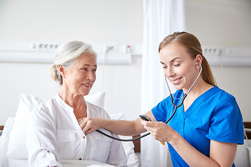 Image showing nurse with stethoscope and senior woman at clinic