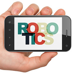 Image showing Science concept: Hand Holding Smartphone with Robotics on  display