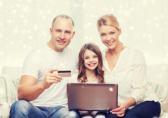 Image showing happy family with laptop computer and credit card