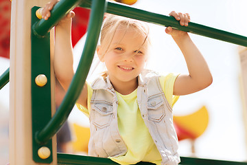 Image showing happy little girl climbing on children playground