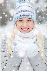 Image showing smiling young woman in winter forest