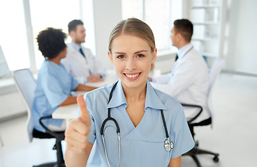 Image showing happy doctor over group of medics at hospital