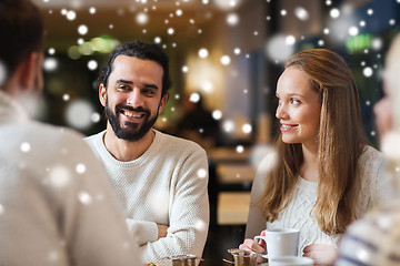Image showing happy friends meeting and drinking tea or coffee
