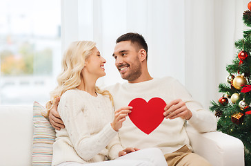 Image showing happy couple with red heart at home for christmas